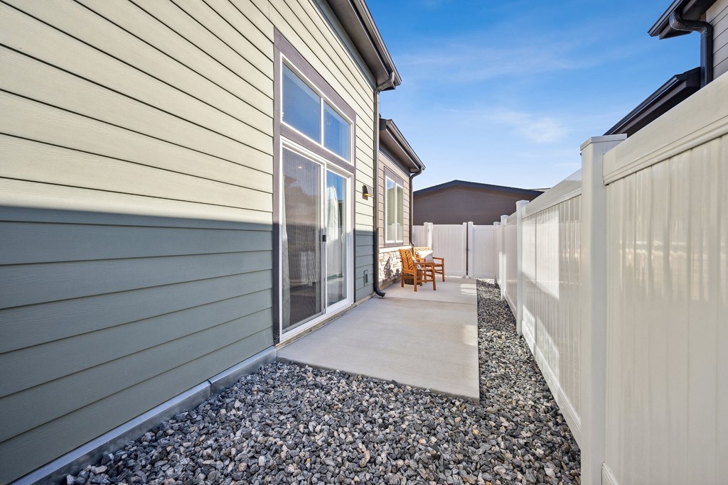 a covered walkway leads to the side of a house at Citadel at Castle Pines, Castle Pines, CO