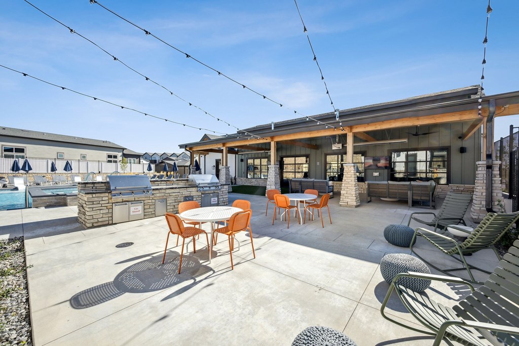 a patio with tables and chairs and a pool at Citadel at Castle Pines, Castle Pines