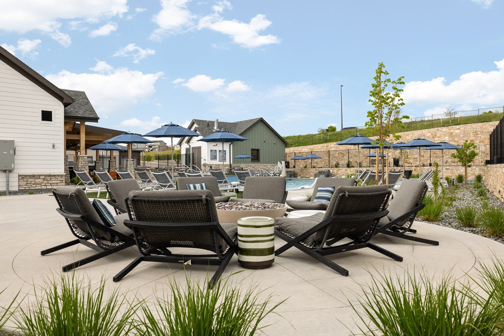 an outdoor patio with chairs and tables and umbrellas