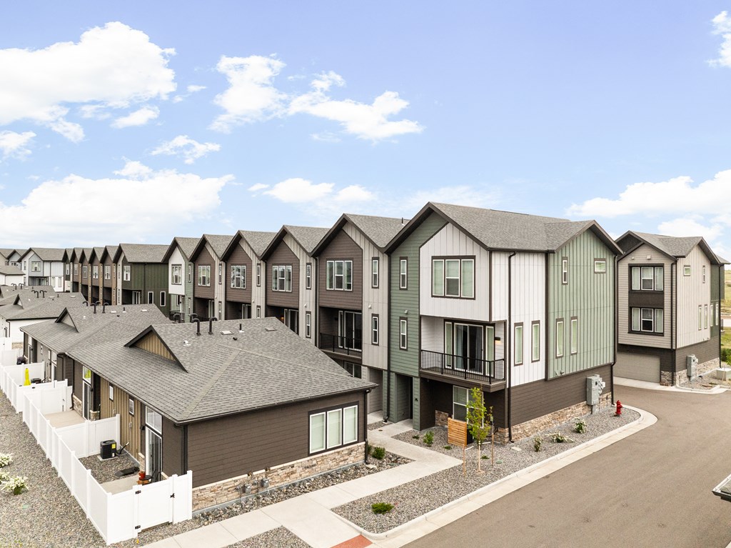 a row of townhomes in front of a street