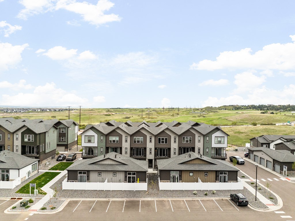 an aerial view of a group of houses in a parking lot