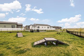 a park with benches and houses in the background
