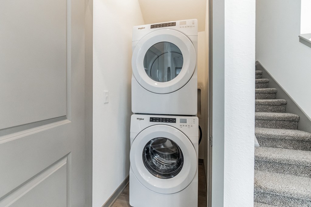 a front load washer and dryer in a laundry room at Slate at Fishers District, Fishers, 46037