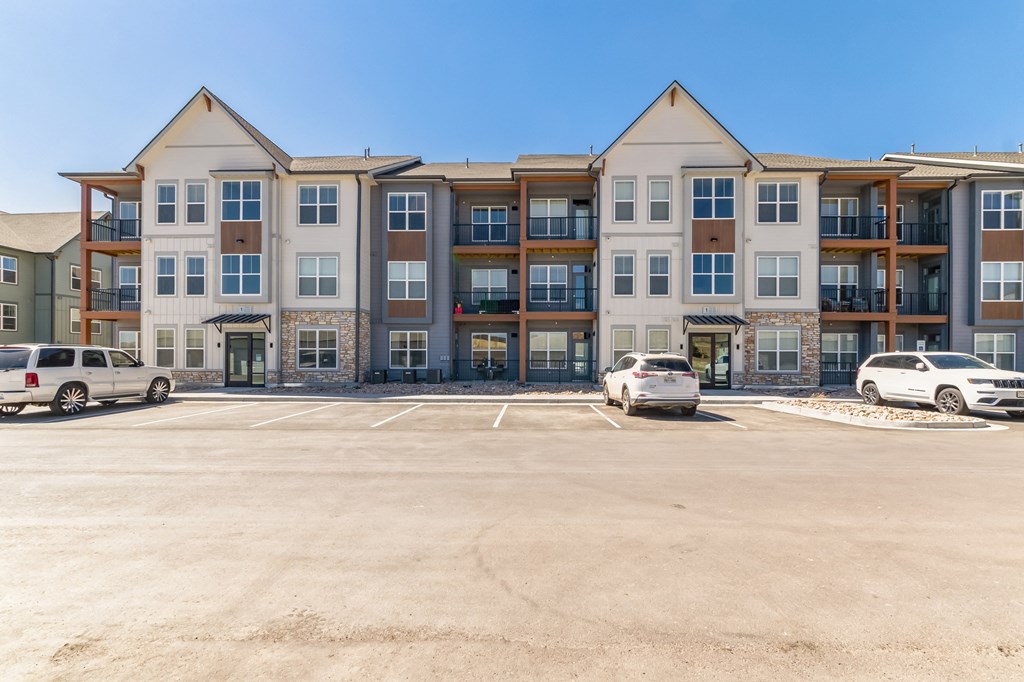 a large parking lot in front of an apartment building  at Upland Flats, Colorado Springs, 80922