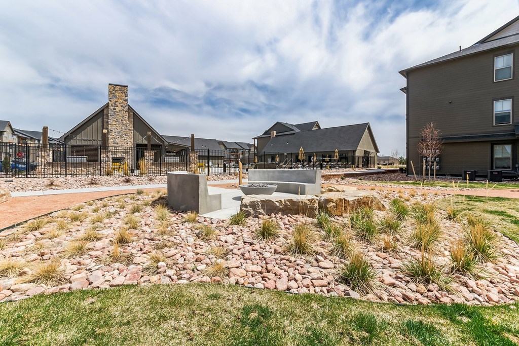 a fire pit sits in the middle of a landscaped yard at Apex, Colorado Springs, CO, 80923