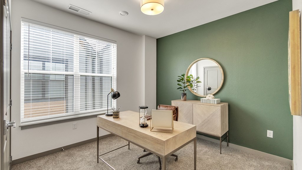 a home office with green walls and a large window at Slate at Fishers District, Indiana, 46037