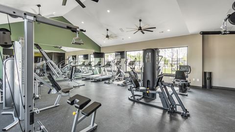 a spacious fitness center with cardio equipment and windows at Slate at Fishers District, Indiana