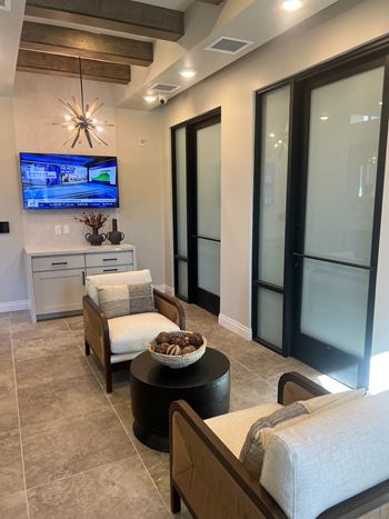 A modern living room with a flat screen TV mounted on the wall at Stella, San Tan Valley, AZ 85143