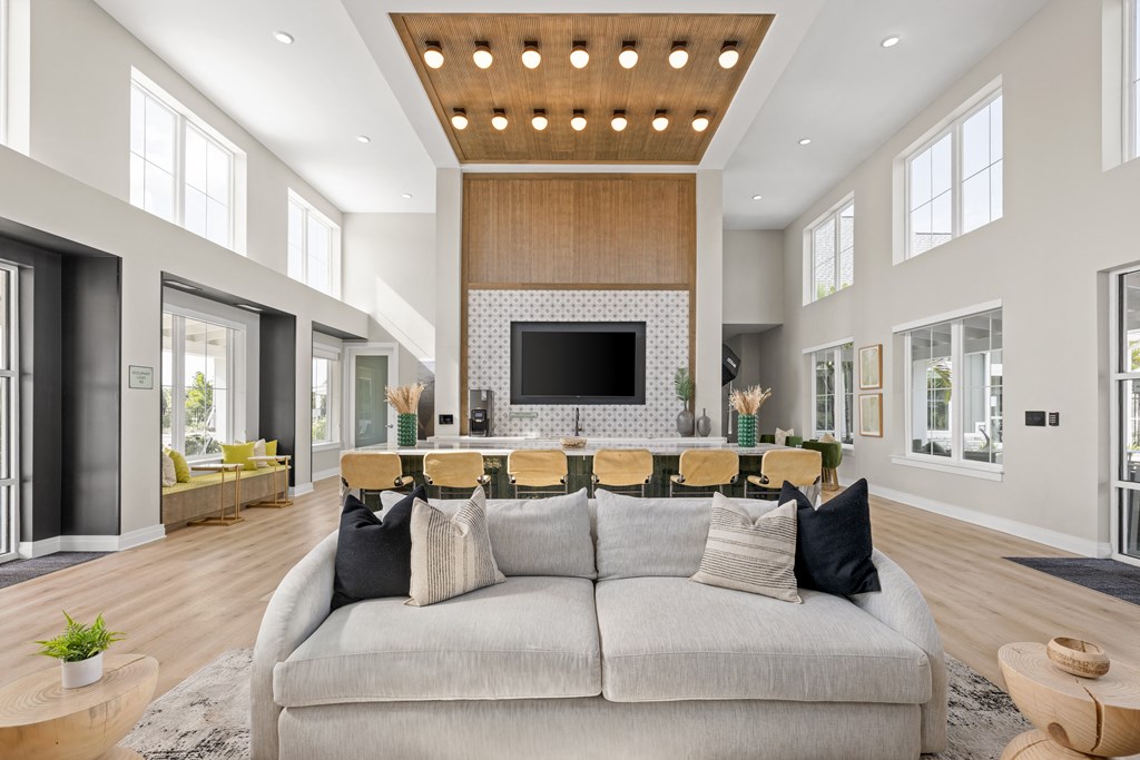 a large living room with a gray couch and a table with chairs at Palm Grove in Ellenton, FL 34222