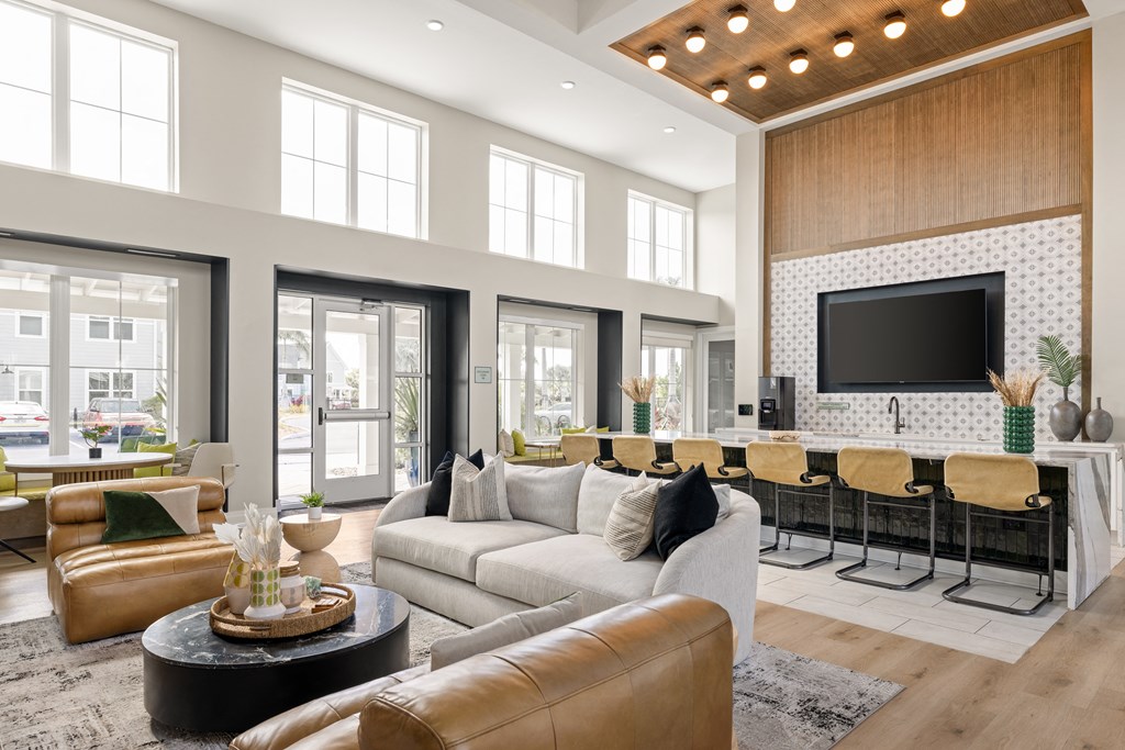 a living room with a couch and a bar and a television at Palm Grove in Ellenton, FL 34222