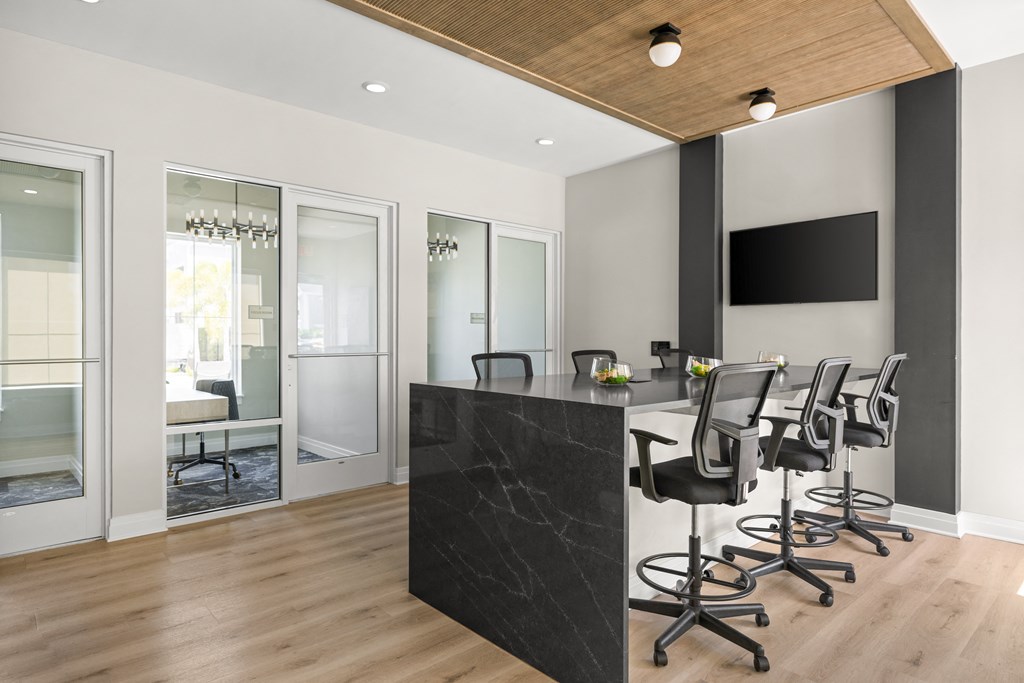 a conference room with a black counter and chairs at Palm Grove in Ellenton, FL 34222