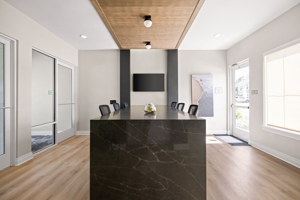 a large office with a black desk and a tv on the wall at Palm Grove in Ellenton, FL 34222