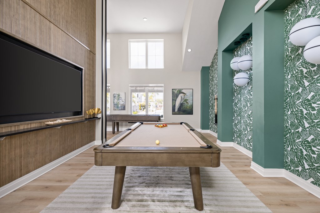 a game room with a pool table and a television at Palm Grove in Ellenton, FL 34222