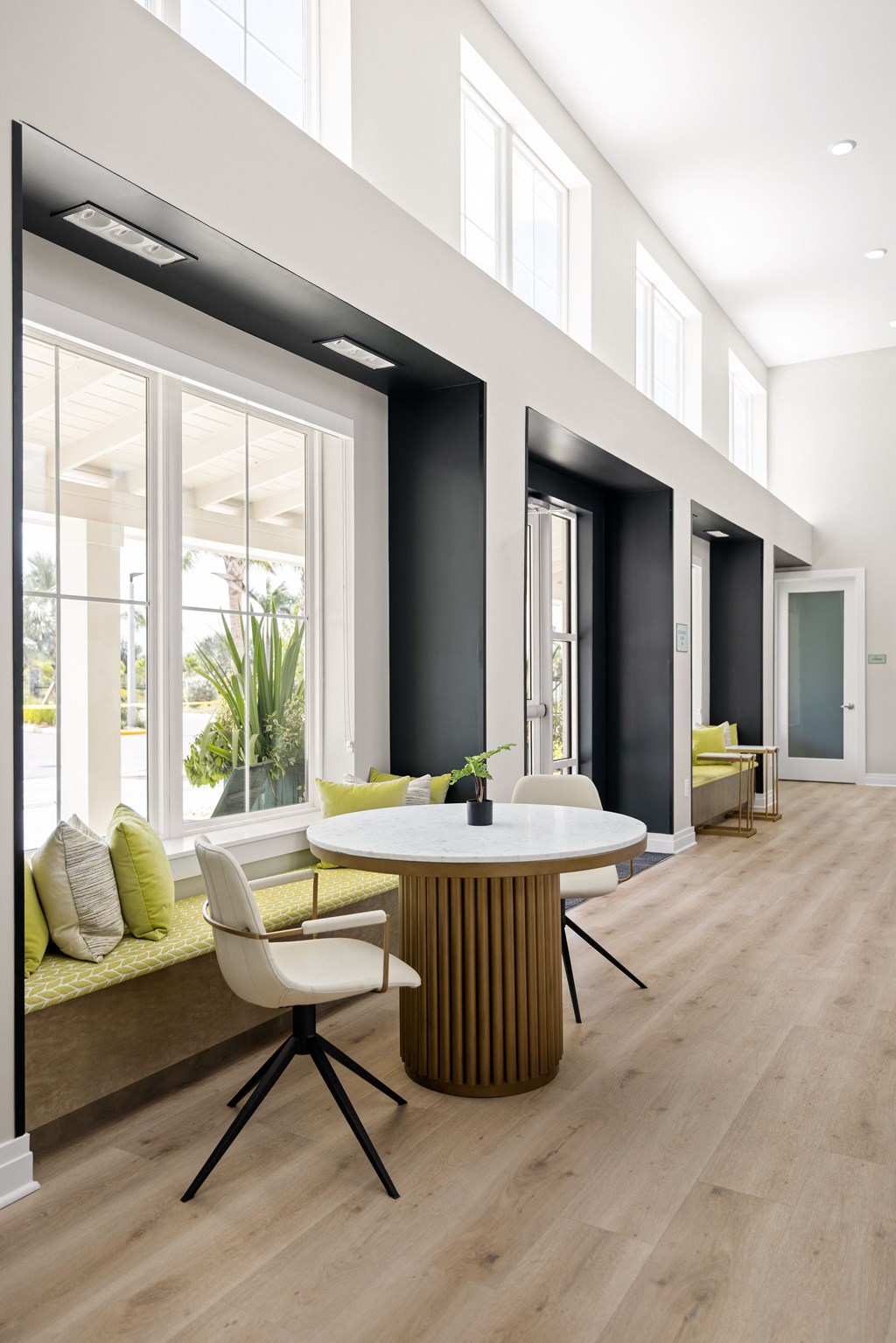 a dining room with a table and chairs in front of a large window at Palm Grove in Ellenton, FL 34222
