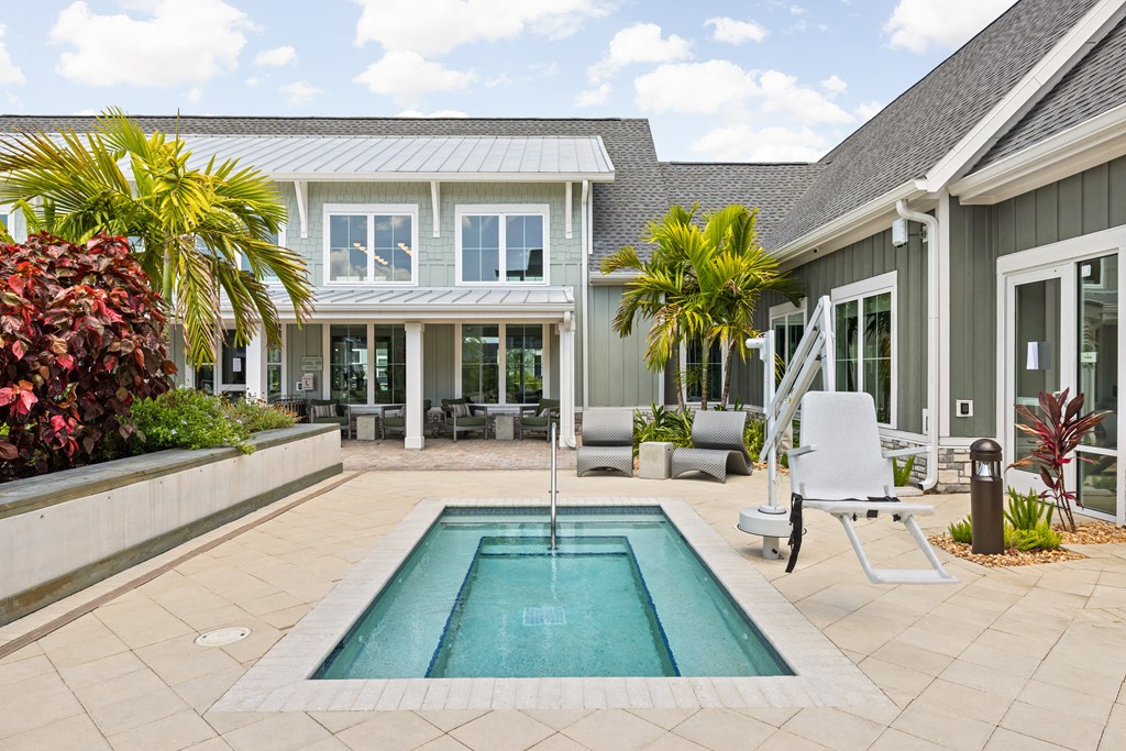 a backyard with a pool and a house at Palm Grove in Ellenton, FL 34222