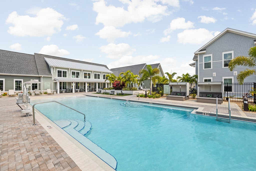 a large swimming pool in front of a building at Palm Grove in Ellenton, FL 34222