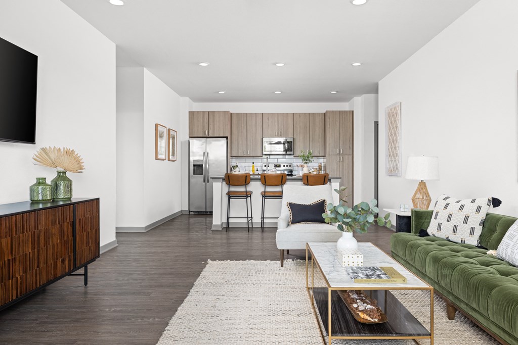 a living room with a couch and a coffee table in front of a kitchen at Palm Grove in Ellenton, FL 34222