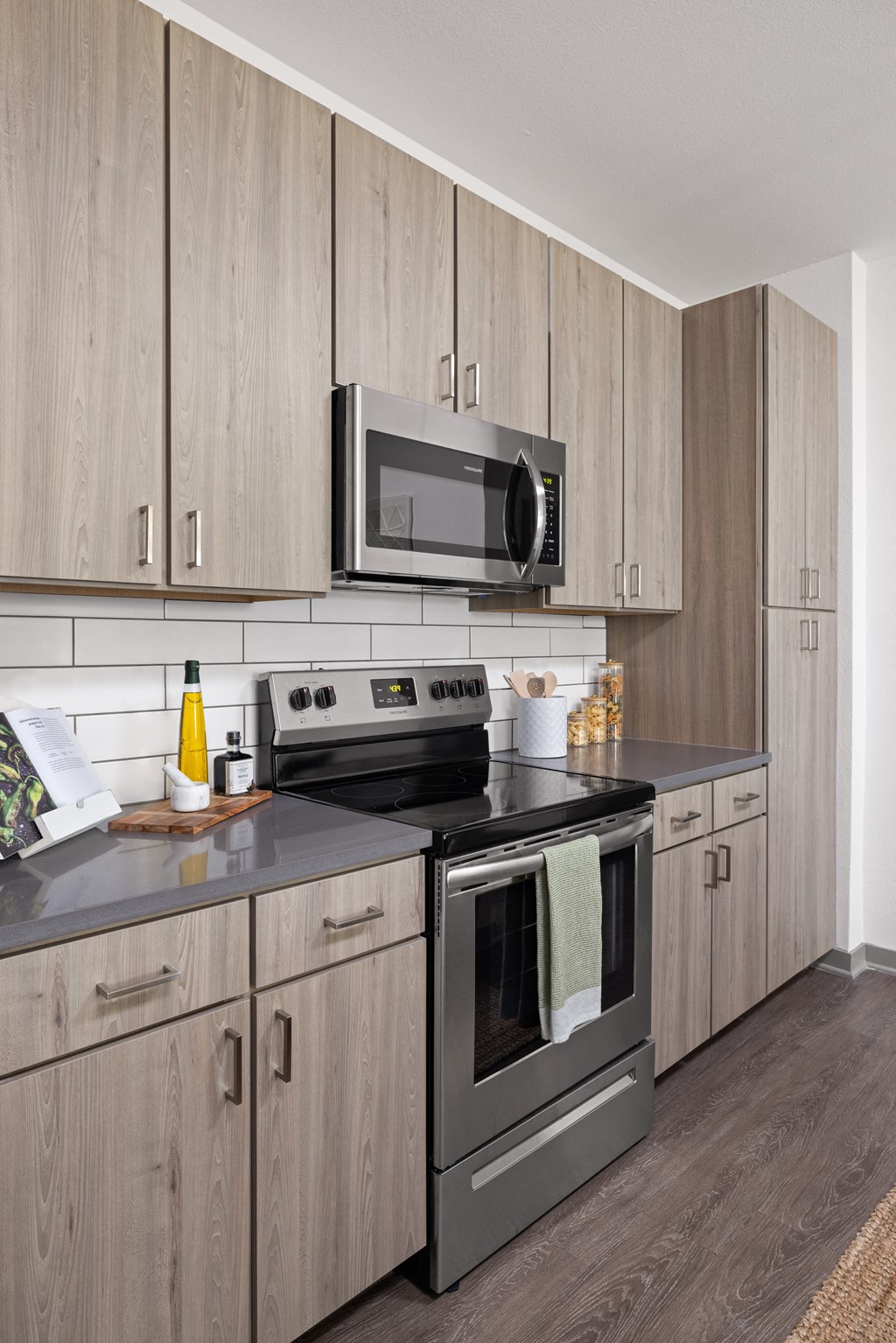 a kitchen with stainless steel appliances and wooden cabinets at Palm Grove in Ellenton, FL 34222
