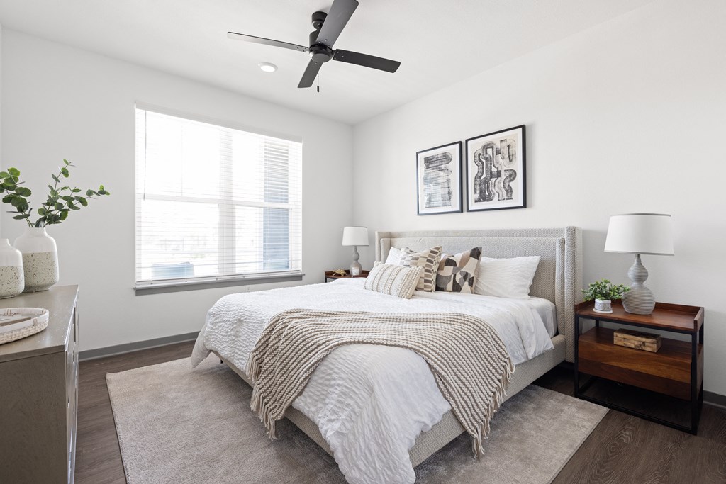 a bedroom with a large bed and a ceiling fan at Palm Grove in Ellenton, FL 34222