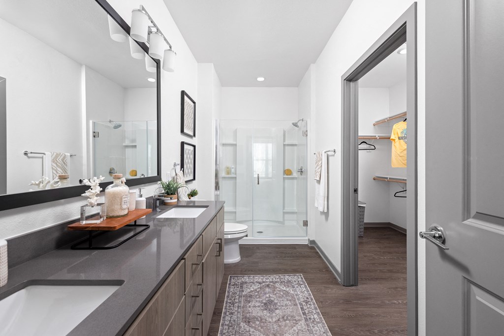 a bathroom with a shower and a sink and a mirror at Palm Grove in Ellenton, FL 34222