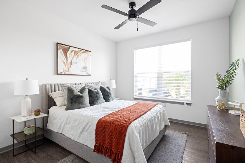 a bedroom with a bed and a ceiling fan at Palm Grove in Ellenton, FL 34222