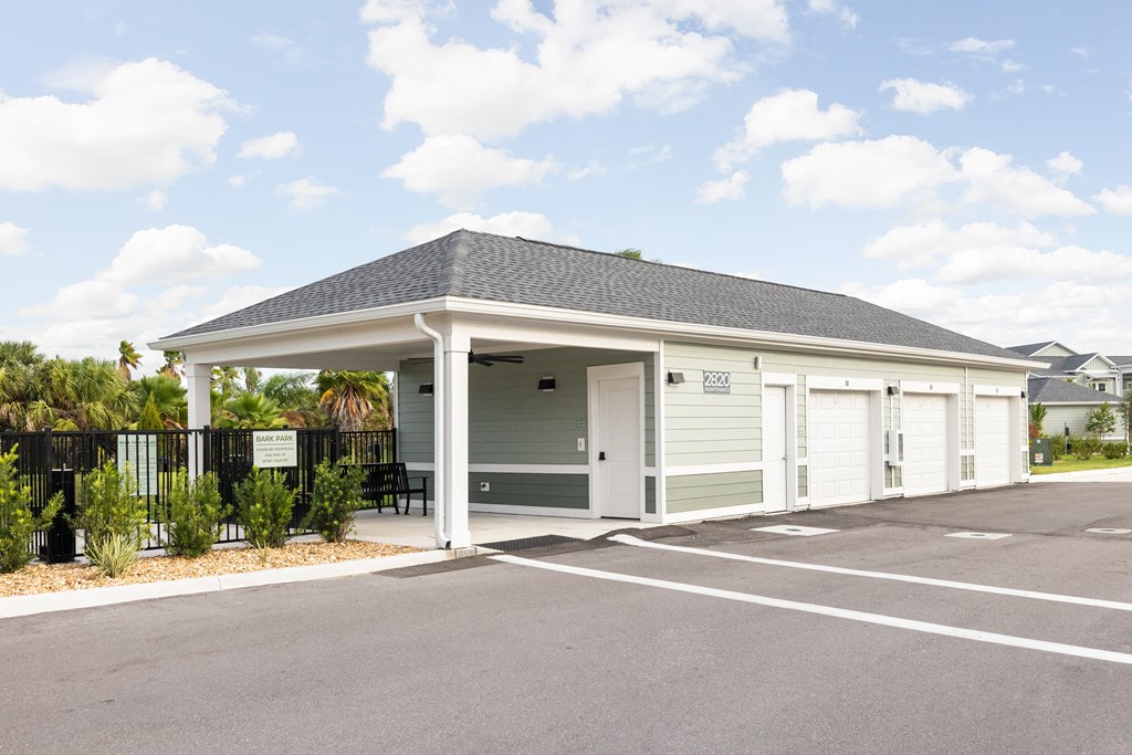 the entrance to a parking lot with a pavilion with a black fence at Palm Grove in Ellenton, FL 34222