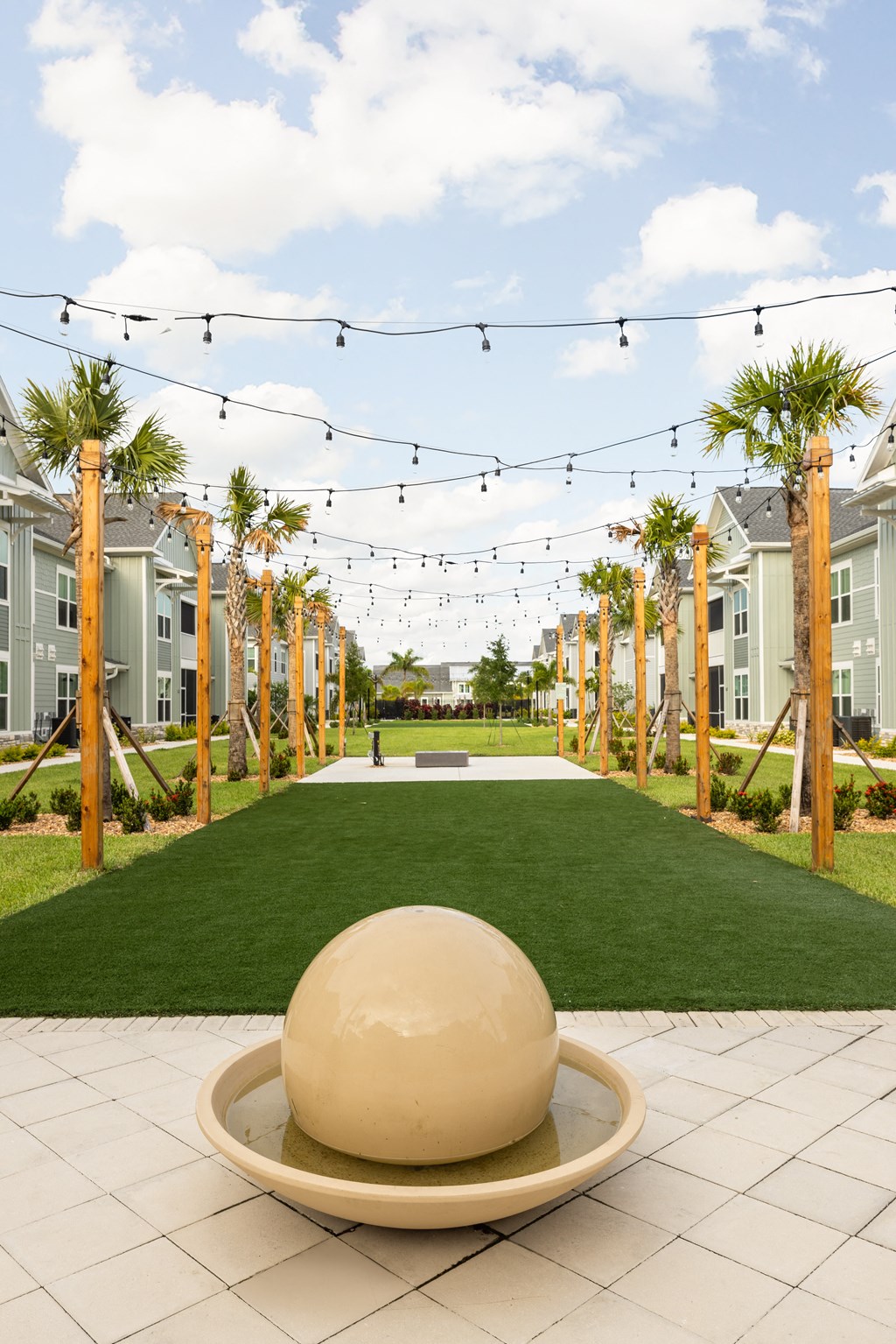a giant ball in the middle of a lawn in a row of houses at Palm Grove in Ellenton, FL 34222