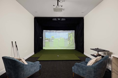 A room with a screen and two chairs.