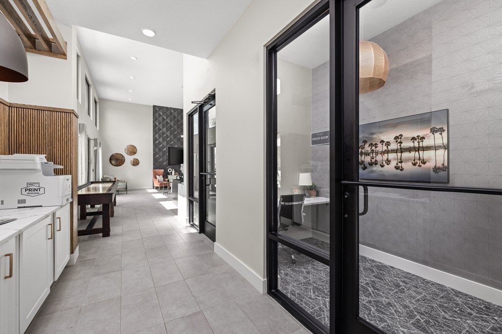 a hallway with a kitchen and a dining room with glass doors at The Sophia, Venice, FL, 34275