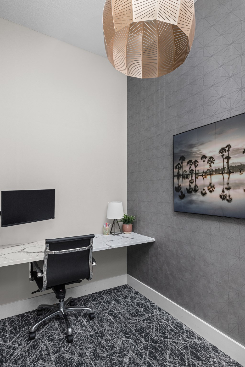 a home office with a desk and a large chandelier at The Sophia, Venice, FL, 34275