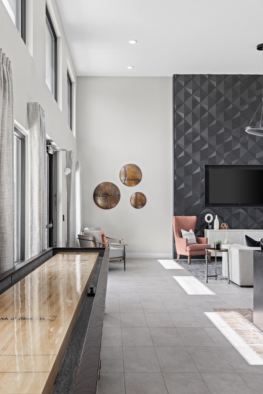a living room with white walls and a large window and a wooden table at The Sophia, Venice, FL, 34275
