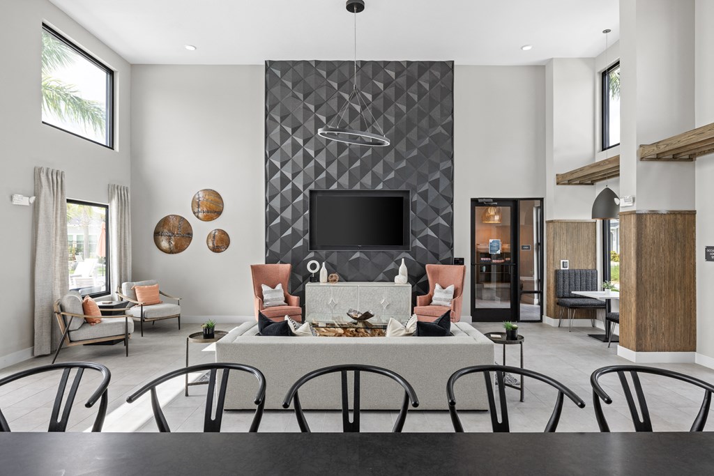 a living room with a fireplace and a table with chairs at The Sophia, Venice, FL, 34275