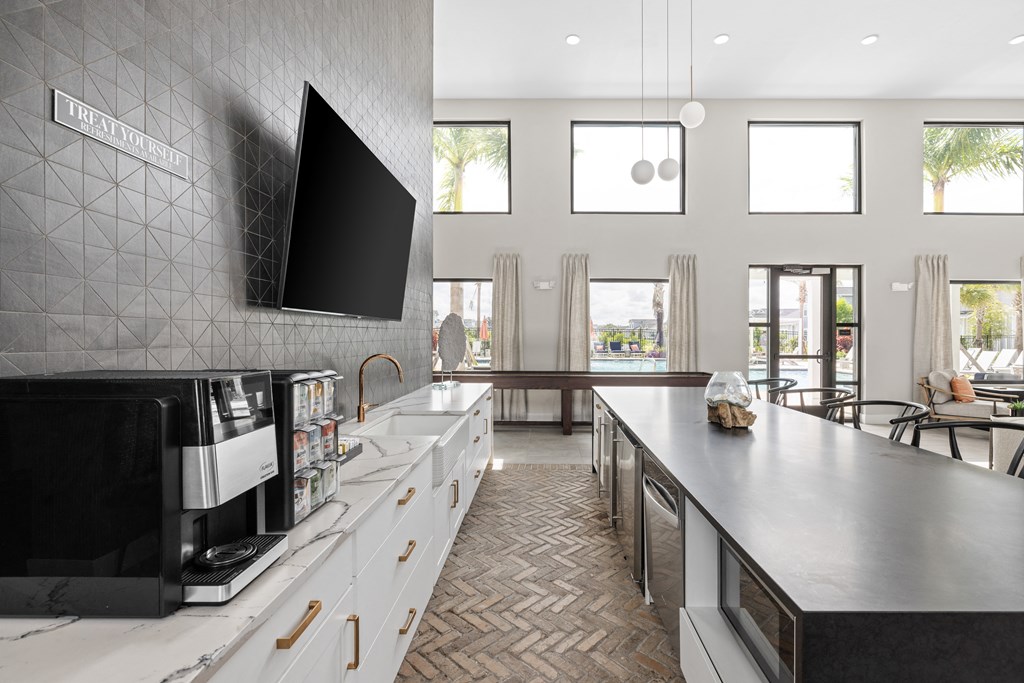 a large kitchen with a large counter and a tv on the wall at The Sophia, Venice, FL, 34275