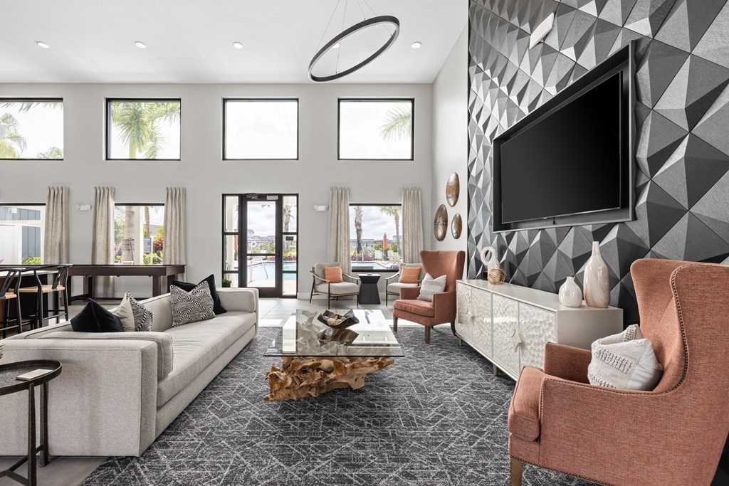 a living room with couches and chairs and a television at The Sophia, Venice, FL, 34275