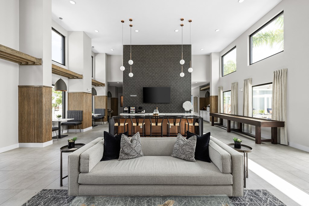 a living room with a couch and a bar in a lobby at The Sophia, Venice, FL, 34275