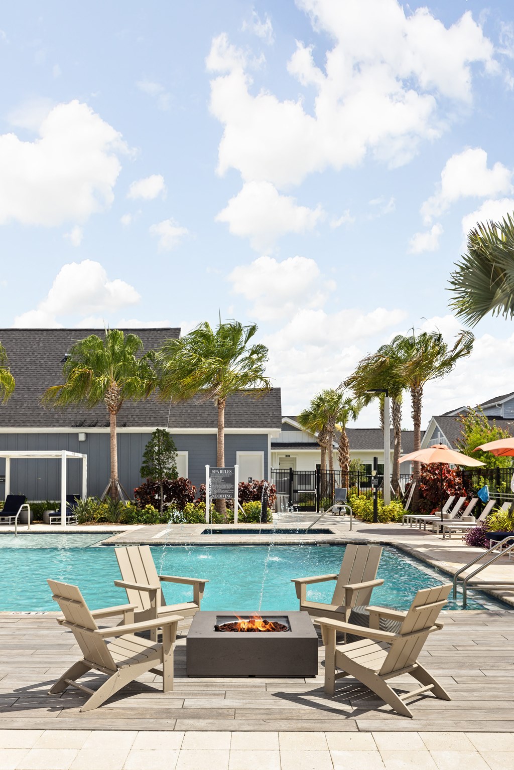 a swimming pool with chairs and a fire pit at The Sophia, Venice, FL, 34275