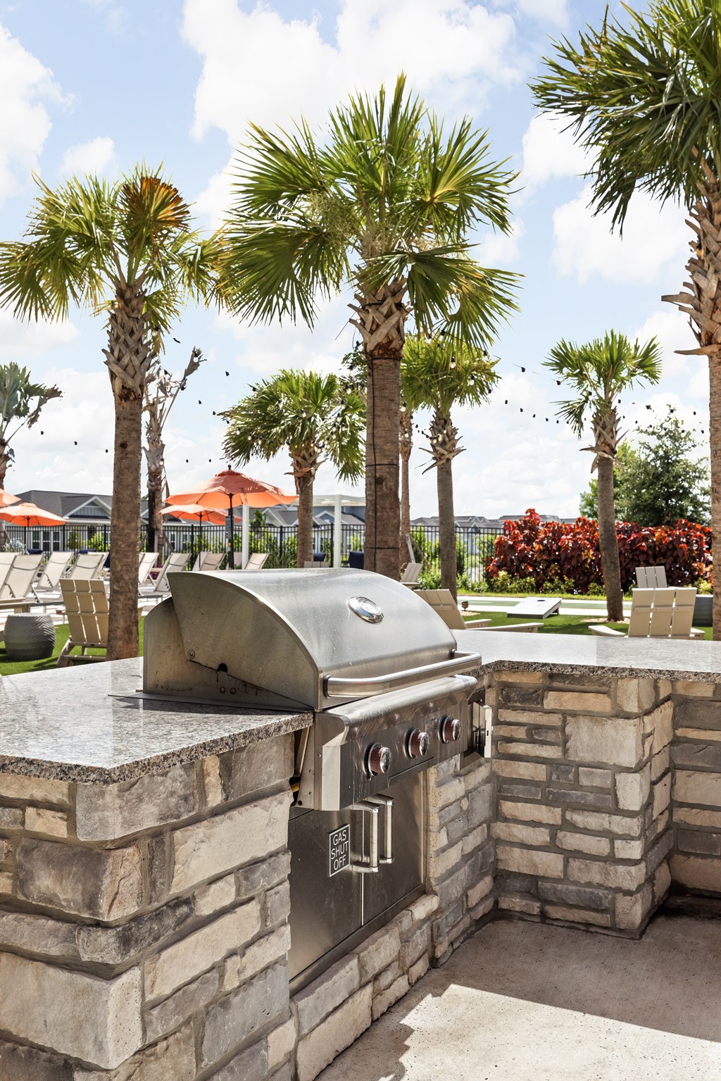 an outdoor barbecue grill with palm trees in the background at The Sophia, Venice, FL, 34275