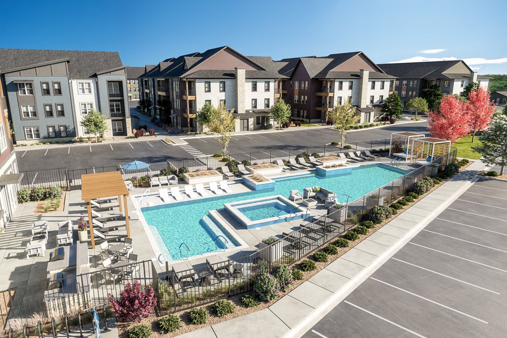 an aerial view of an apartment complex with a swimming pool and patio furniture at The Quarry, Fort Collins, CO 80526