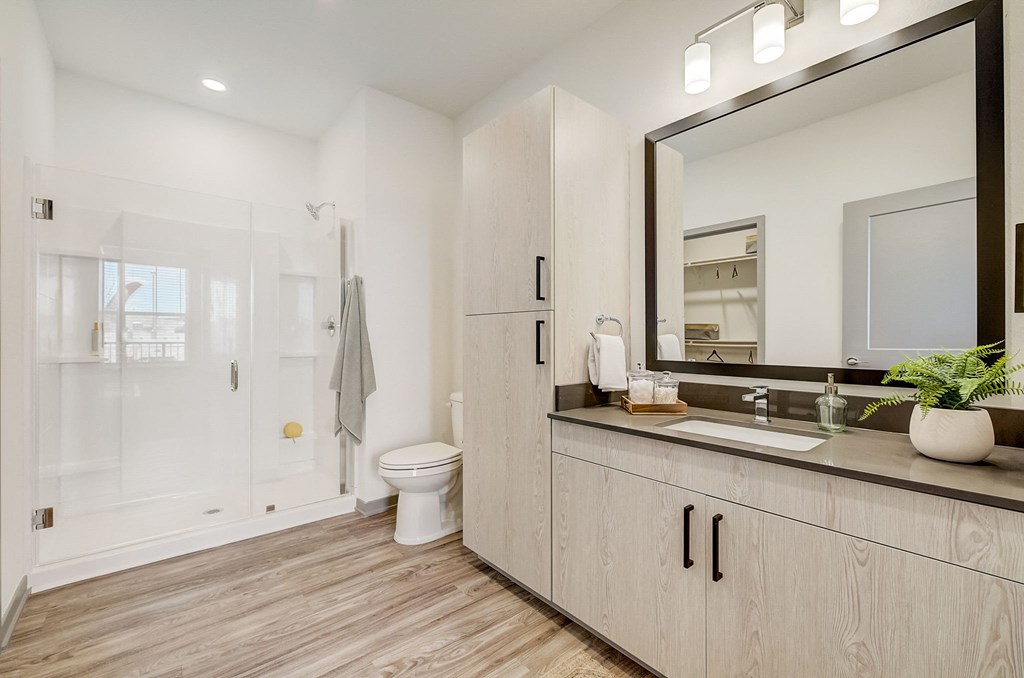 a white bathroom with a large mirror and a toilet at Alta25, Monument, Colorado