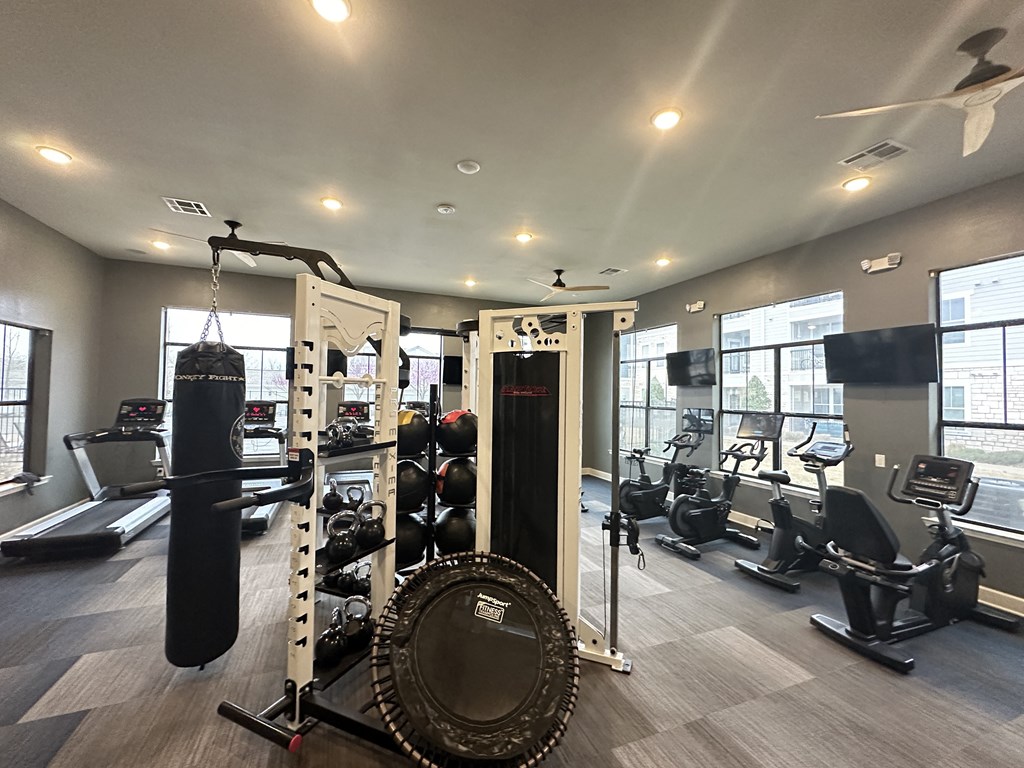 a gym with weights and a punching bag on the floor at Watermark at Steele Crossing, Arkansas