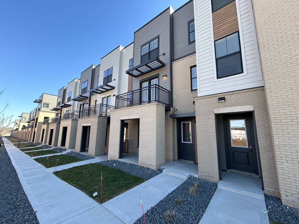 a row of modern apartments with balconies and grass at Meridian at CityPlace, Minnesota, 55125