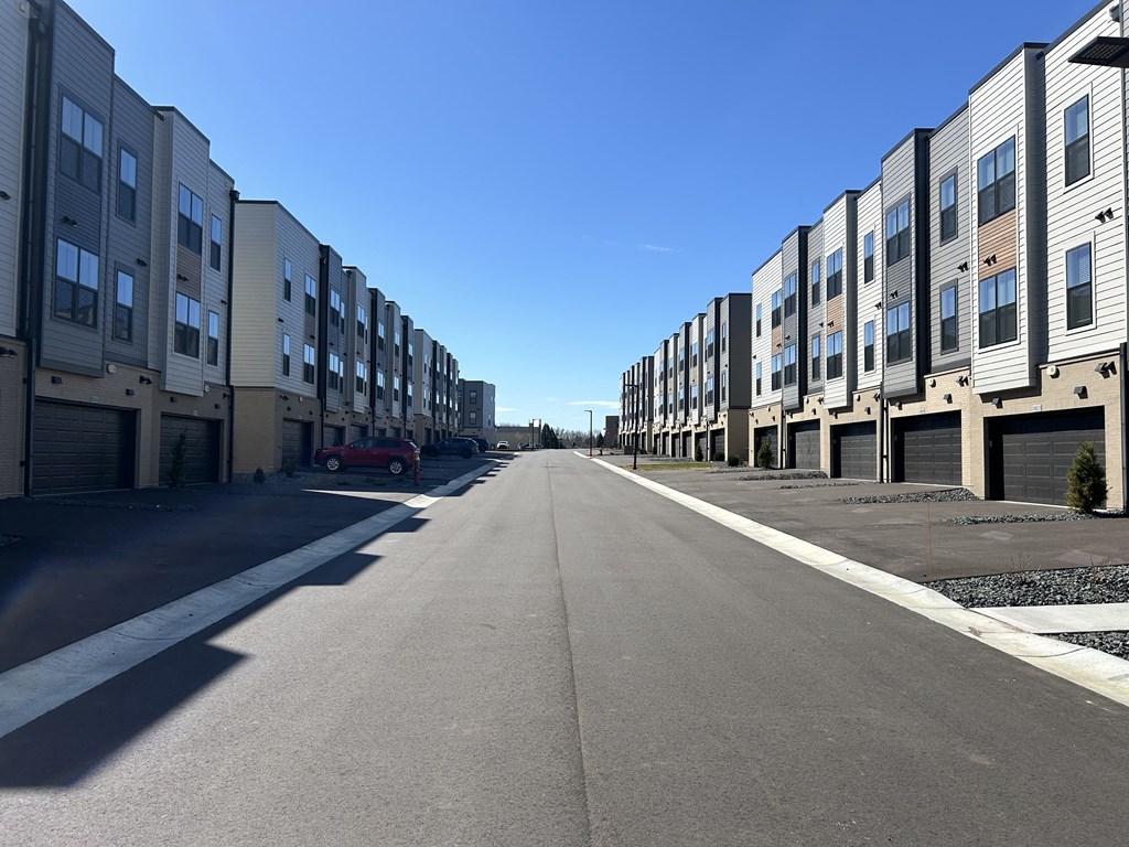 a row of apartment buildings on the side of a street at Meridian at CityPlace, Woodbury, MN