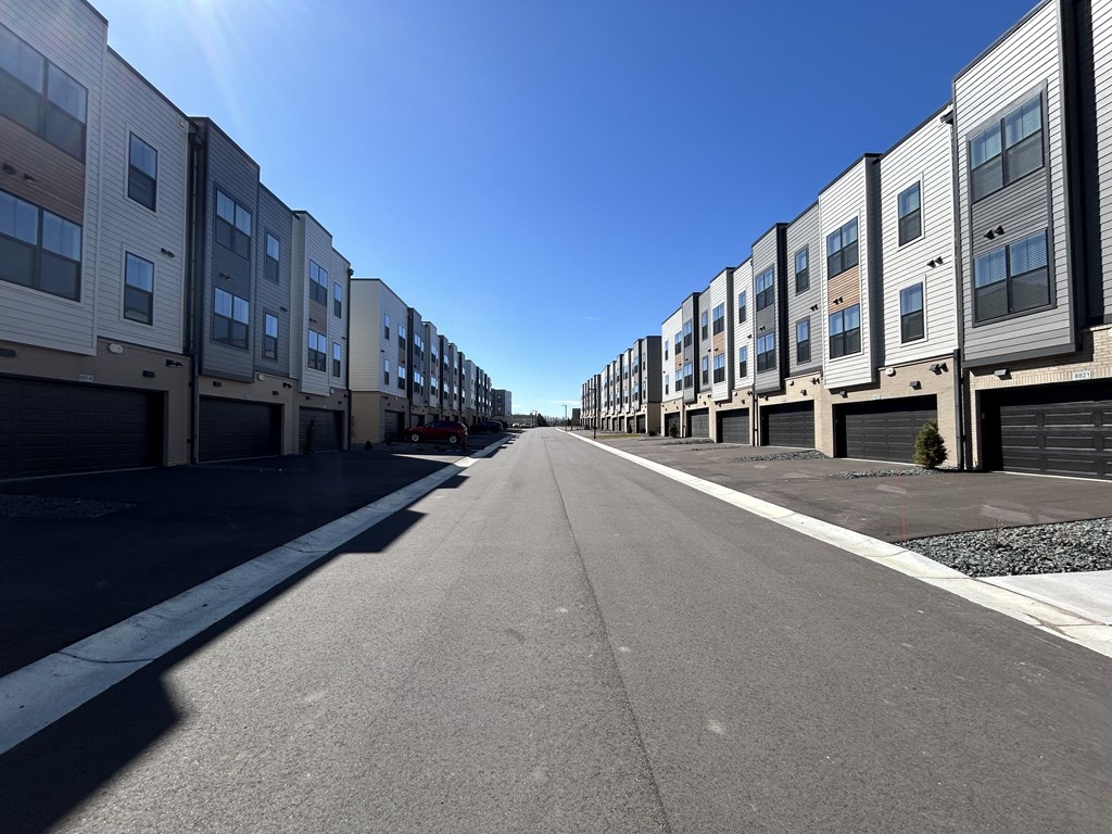 a row of apartment buildings on the side of a street at Meridian at CityPlace, Woodbury, 55125
