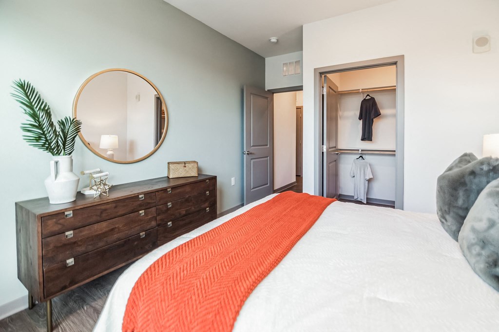 a bedroom with a bed and a dresser and a closet  at Palm Grove, Ellenton, Florida