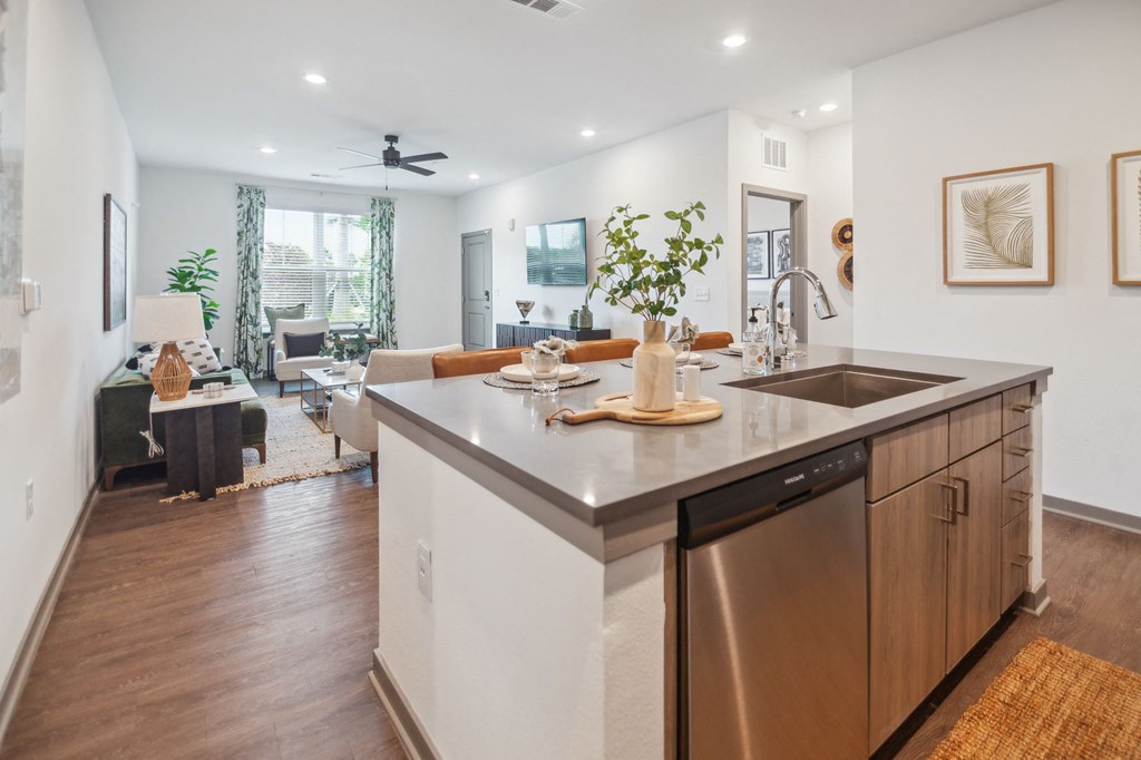 a kitchen with an island and a living room with a couch  at Palm Grove, Ellenton