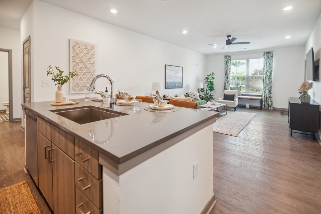 a kitchen with an island and a living room with a couch  at Palm Grove, Florida, 34222