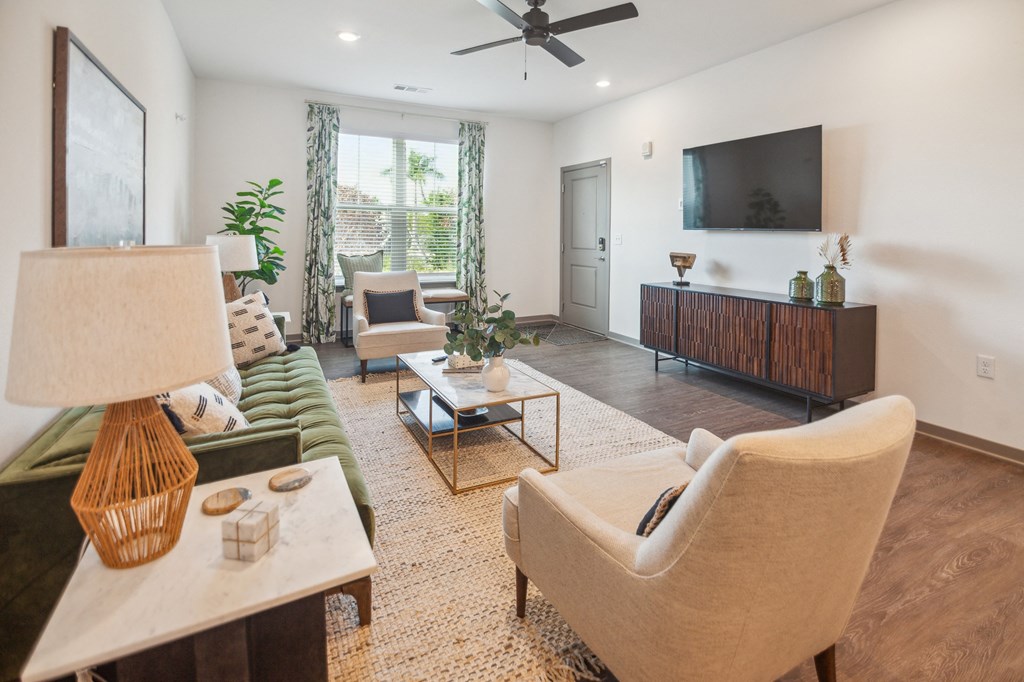 a living room with couches and chairs and a television  at Palm Grove, Ellenton
