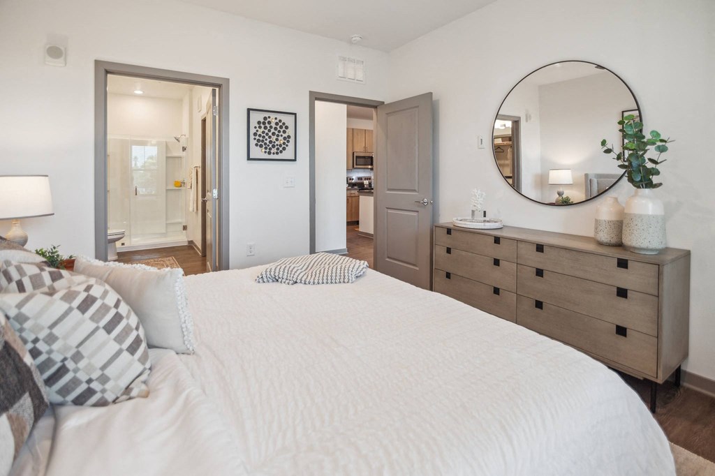 a bedroom with a large bed and a mirror  at Palm Grove, Ellenton, FL