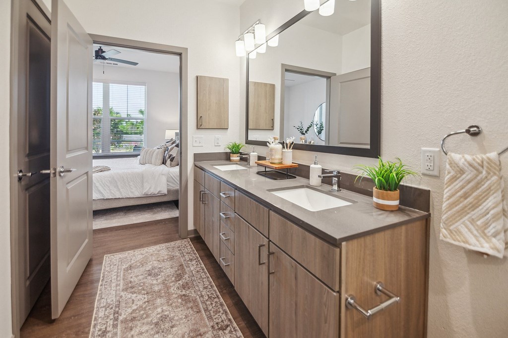 a bathroom with a sink and a mirror and a door to a bedroom  at Palm Grove, Florida, 34222