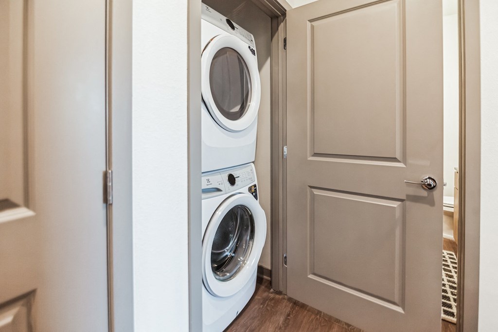 a washer and dryer in a small laundry room with a door  at Palm Grove, Ellenton